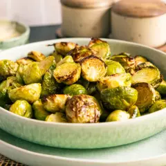 Knuspriger rosenkohl im airfryer, goldbraun und appetitlich in einer Schüssel serviert.