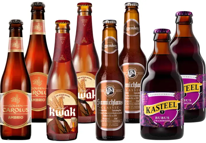 Verschiedene bockbier sorten, darunter Gouden Carolus Ambrio, Pauwel Kwak und Kasteel Rubus Framboise, in Glasflaschen.