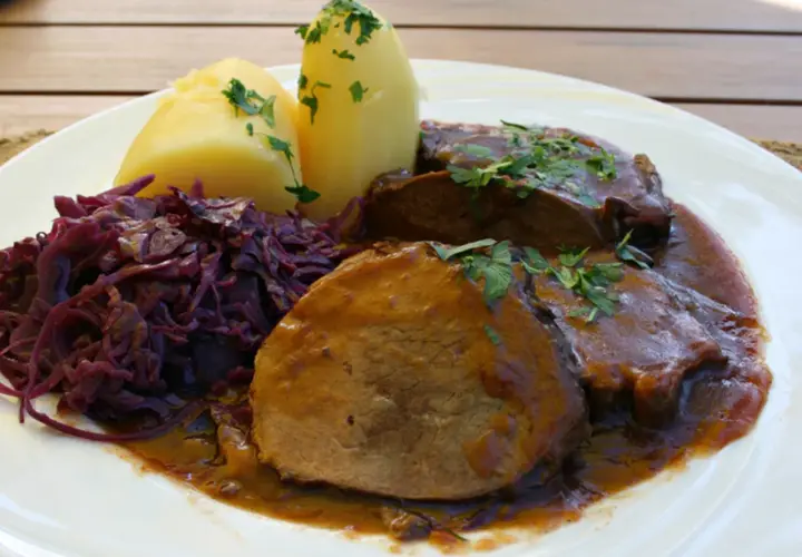 Schmorbraten vom Hirsch, zart und saftig, mit Salzkartoffeln und Rotkohl. Ein klassisches Rezept für Hirschbraten geschmort.