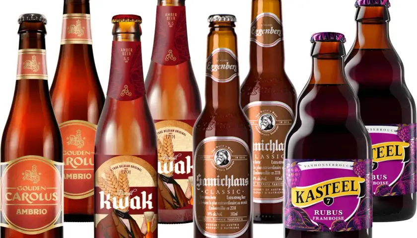 Verschiedene bockbier sorten, darunter Gouden Carolus Ambrio, Pauwel Kwak und Kasteel Rubus Framboise, in Glasflaschen.