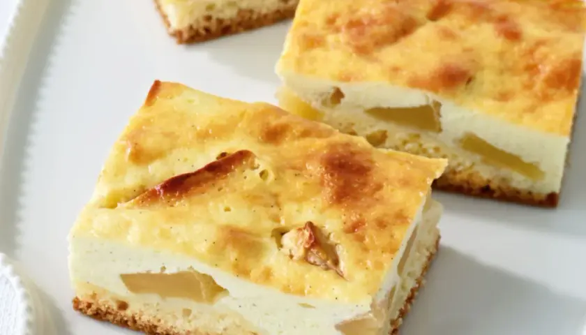 Saftiger Apfelkuchen aus der Kastenform mit einer cremigen Quarkschicht und zarten Apfelstücken.