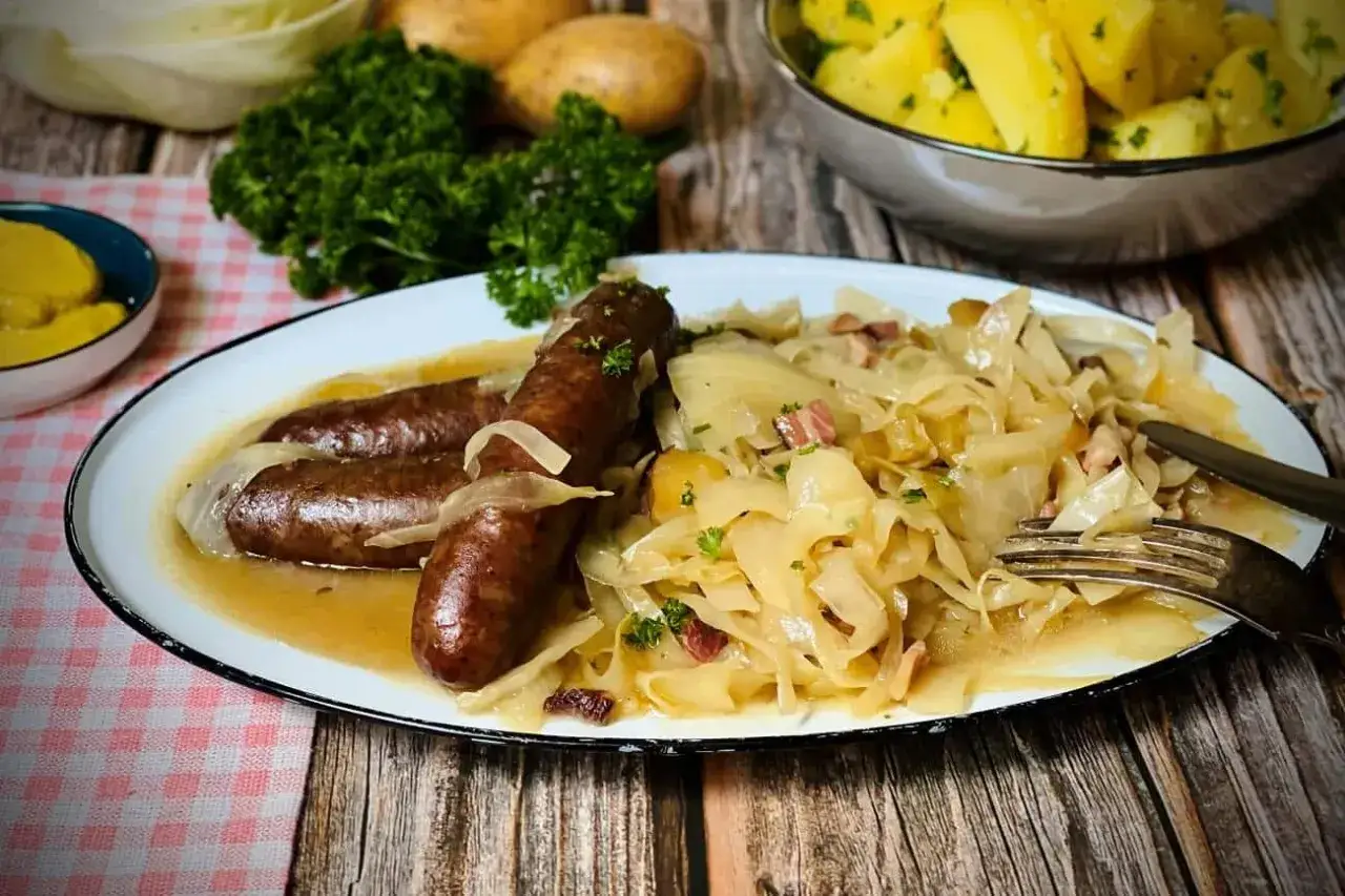 Deftiges Sauerkraut mit Bratw&uuml;rsten und Kartoffeln, ein klassisches Oktoberfest-Rezept.
